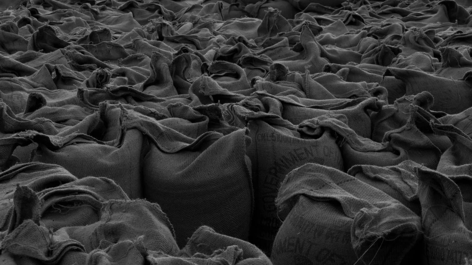 Stacked sacks in a warehouse, black and white